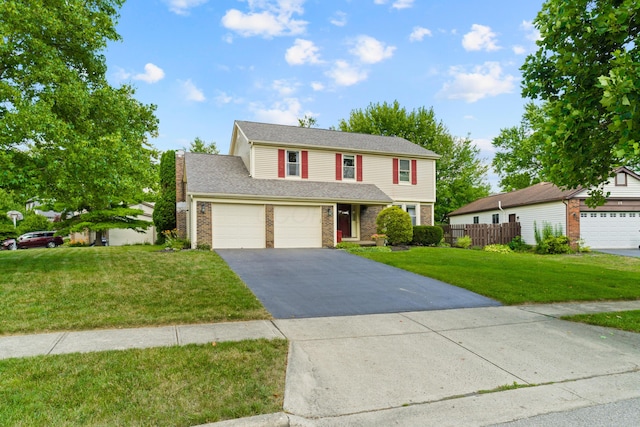9 Intermeadows Way, Powell, OH 43065 - traditional home with asphalt driveway, brick siding, and an attached garage