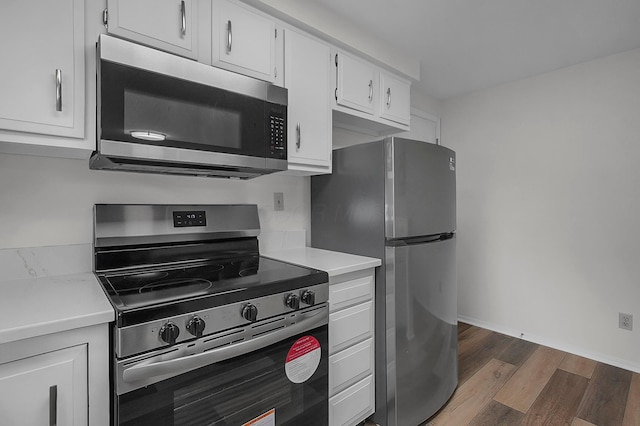 764 Towne Krier Ct, Newark, OH 43055 - kitchen featuring appliances with stainless steel finishes, dark wood-style flooring, light countertops, and white cabinets