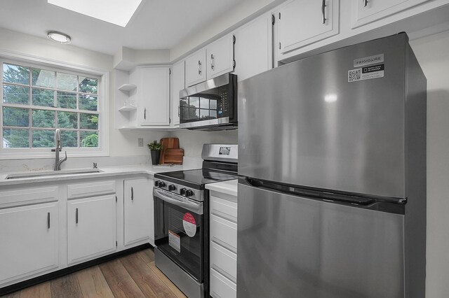 764 Towne Krier Ct, Newark, OH 43055 - kitchen featuring appliances with stainless steel finishes, light countertops, dark wood finished floors, white cabinets, and open shelves