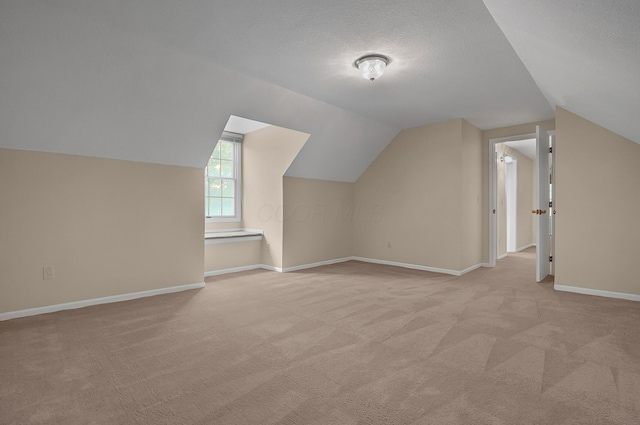 764 Towne Krier Ct, Newark, OH 43055 - bonus room featuring light colored carpet, vaulted ceiling, and a textured ceiling