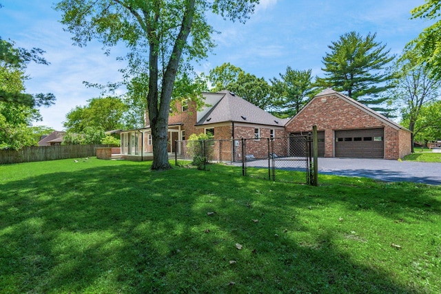 1120 Fairway Blvd, Columbus, OH 43213 - view of yard with a garage, asphalt driveway, and a gate