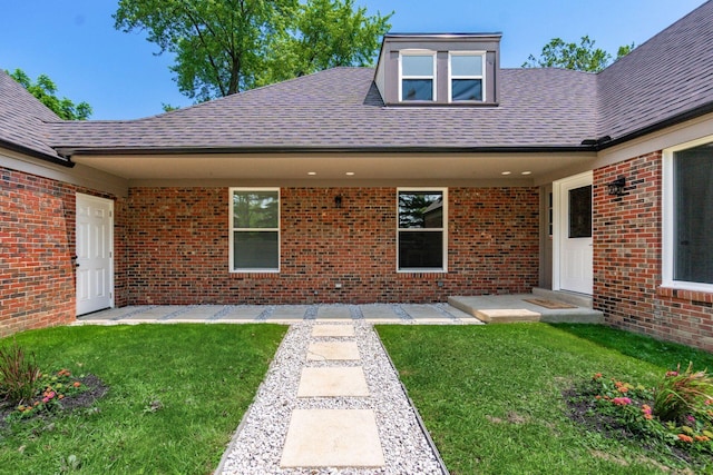 1120 Fairway Blvd, Columbus, OH 43213 - entrance to property featuring a shingled roof, a yard, and brick siding