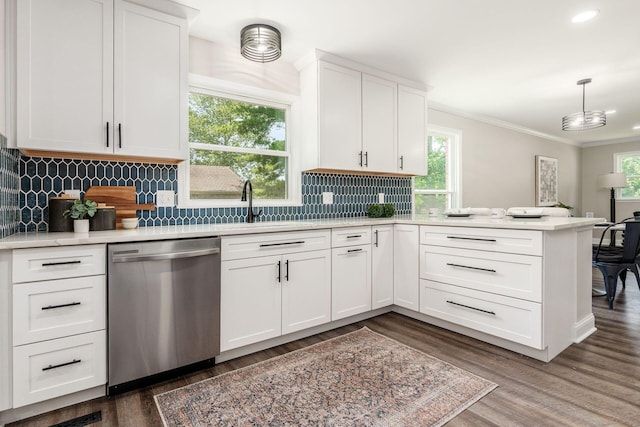 1120 Fairway Blvd, Columbus, OH 43213 - kitchen with stainless steel dishwasher, a peninsula, light countertops, ornamental molding, and dark wood-style flooring