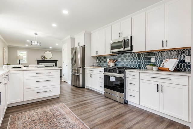1120 Fairway Blvd, Columbus, OH 43213 - kitchen with stainless steel appliances, ornamental molding, tasteful backsplash, recessed lighting, and wood finished floors