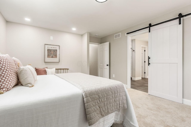 1120 Fairway Blvd, Columbus, OH 43213 - bedroom with a barn door, carpet flooring, and recessed lighting