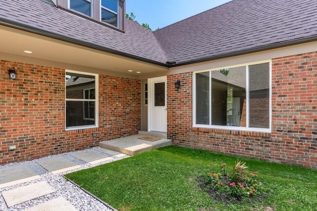 1120 Fairway Blvd, Columbus, OH 43213 - property entrance with brick siding, a shingled roof, and a lawn