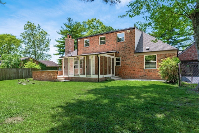 1120 Fairway Blvd, Columbus, OH 43213 - back of property featuring a chimney, a sunroom, brick siding, entry steps, and a shingled roof