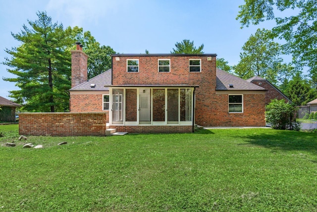 1120 Fairway Blvd, Columbus, OH 43213 - rear view of house featuring a chimney, a lawn, and brick siding