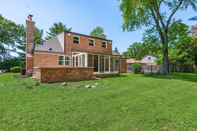 1120 Fairway Blvd, Columbus, OH 43213 - rear view of house with a chimney, a sunroom, and brick siding