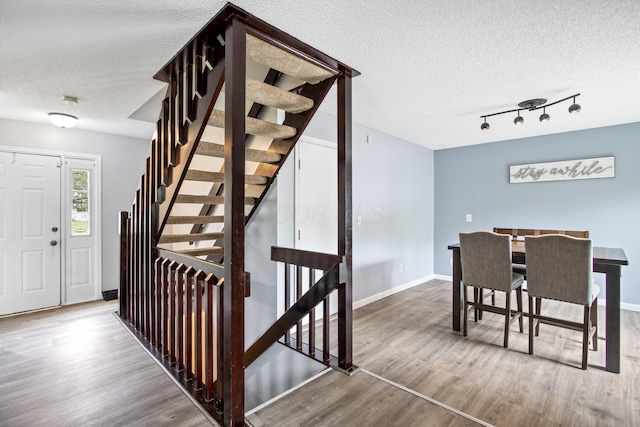 3124 Hillrose Dr, Hilliard, OH 43026 - stairway with a textured ceiling, wood finished floors, and track lighting