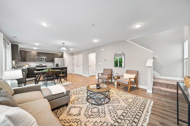 1364 Robinof Dr, Grove City, OH 43123 - living room featuring light wood-style floors, recessed lighting, and stairway