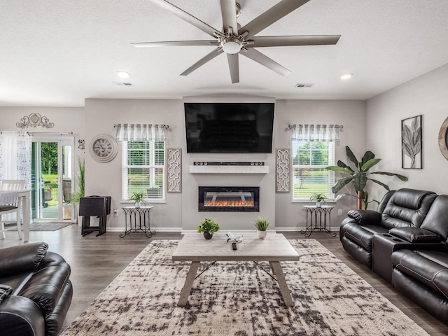 326 Mannaseh Dr W, Granville, OH 43023 - living room featuring plenty of natural light, a ceiling fan, a glass covered fireplace, wood finished floors, and recessed lighting