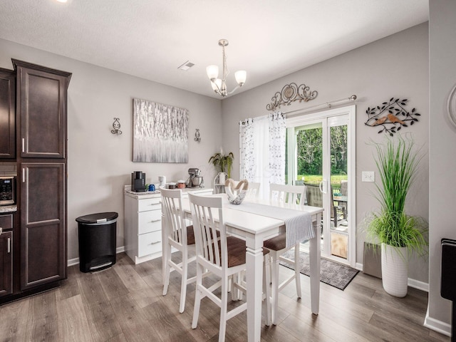 326 Mannaseh Dr W, Granville, OH 43023 - dining space with wood finished floors and a chandelier