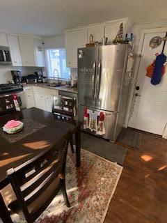 5510 Coopers Hawk Cir, Dublin, OH 43016 - kitchen with appliances with stainless steel finishes, white cabinets, and dark wood-style floors