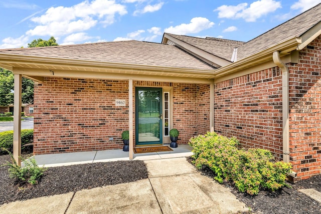 9460 Clermont Cir, Powell, OH 43065 - property entrance with a shingled roof and brick siding
