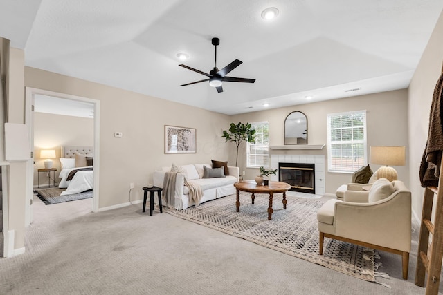 9460 Clermont Cir, Powell, OH 43065 - carpeted living area featuring a tile fireplace, ceiling fan, and recessed lighting