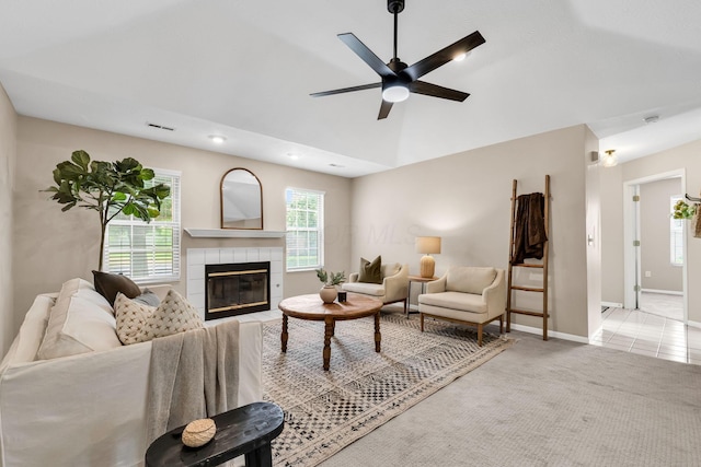 9460 Clermont Cir, Powell, OH 43065 - living room featuring a ceiling fan, a tiled fireplace, light colored carpet, and lofted ceiling
