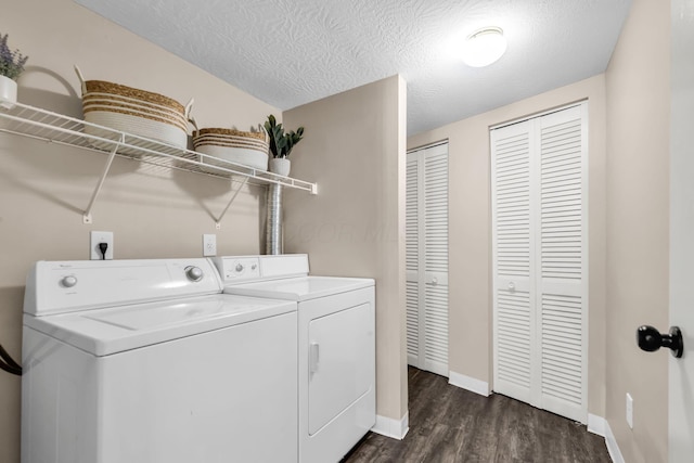 9460 Clermont Cir, Powell, OH 43065 - laundry room with washer and clothes dryer, dark wood-type flooring, and a textured ceiling