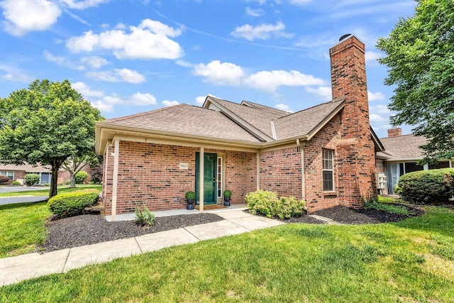 9460 Clermont Cir, Powell, OH 43065 - ranch-style home with brick siding, a front yard, roof with shingles, and a chimney