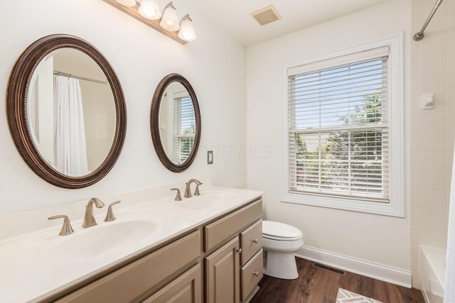 5866 Morganwood Sq, Hilliard, OH 43026 - bathroom featuring plenty of natural light, double vanity, wood finished floors, and shower / tub combo with curtain