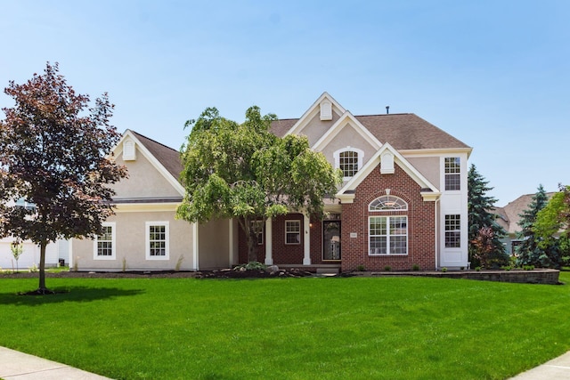 5866 Morganwood Sq, Hilliard, OH 43026 - view of front of house featuring a front lawn, stucco siding, and brick siding