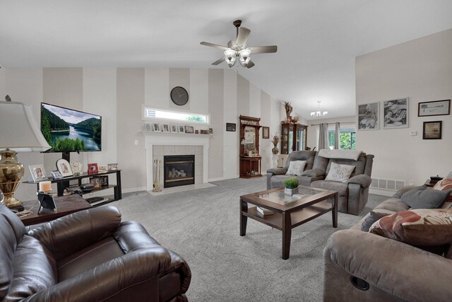 5405 Boucher Dr, Orient, OH 43146 - carpeted living area featuring a ceiling fan, a tiled fireplace, a chandelier, and high vaulted ceiling