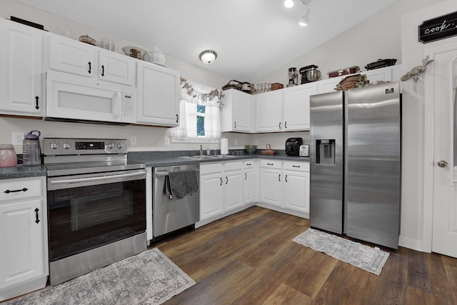 5405 Boucher Dr, Orient, OH 43146 - kitchen with appliances with stainless steel finishes, lofted ceiling, dark countertops, and white cabinets