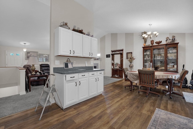 5405 Boucher Dr, Orient, OH 43146 - kitchen featuring dark wood finished floors, a chandelier, dark countertops, white cabinetry, and lofted ceiling
