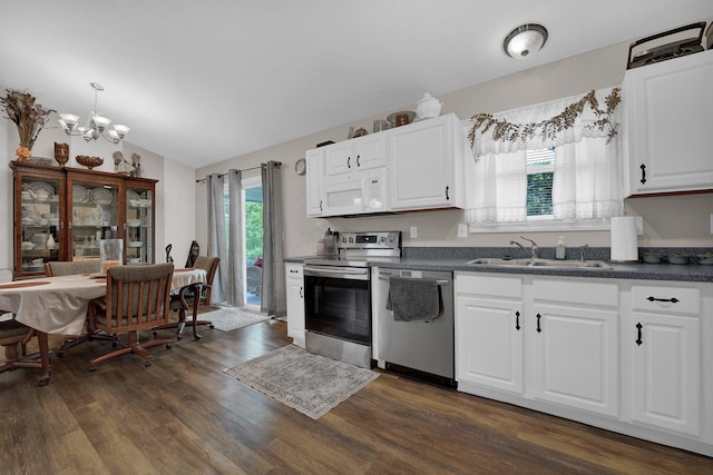 5405 Boucher Dr, Orient, OH 43146 - kitchen with appliances with stainless steel finishes, dark countertops, a chandelier, dark wood finished floors, and lofted ceiling