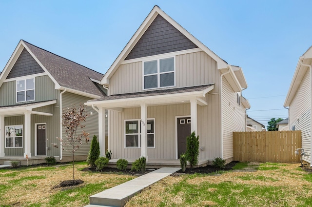 605 Frebis Ave, Columbus, OH 43206 - view of front of house featuring covered porch, roof with shingles, and board and batten siding