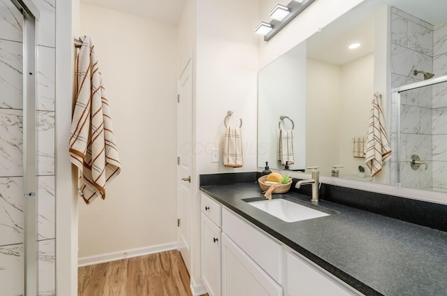 605 Frebis Ave, Columbus, OH 43206 - full bathroom featuring vanity, a marble finish shower, and wood finished floors