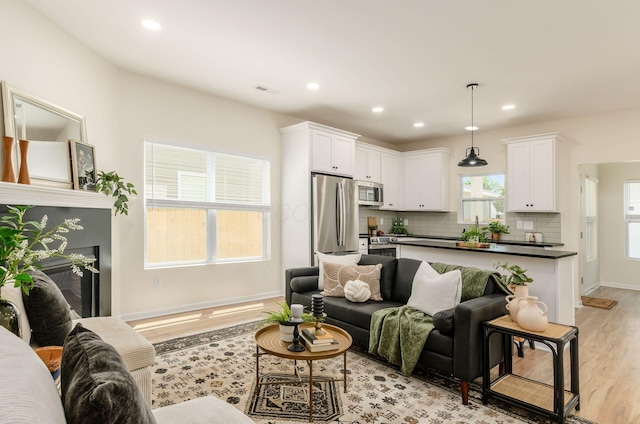 605 Frebis Ave, Columbus, OH 43206 - living room featuring light wood-style flooring, recessed lighting, and a fireplace