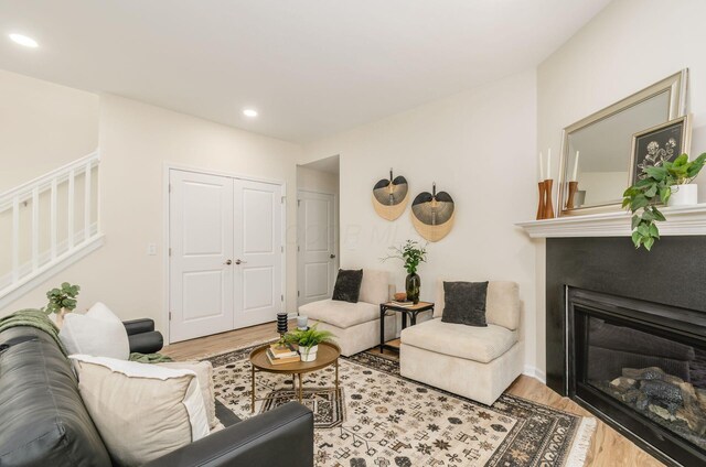 605 Frebis Ave, Columbus, OH 43206 - living area featuring light wood-style flooring, recessed lighting, stairway, and a glass covered fireplace