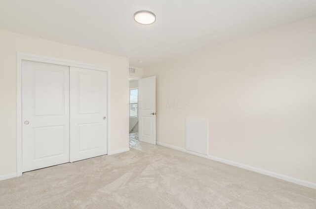 605 Frebis Ave, Columbus, OH 43206 - unfurnished bedroom with light carpet and a closet