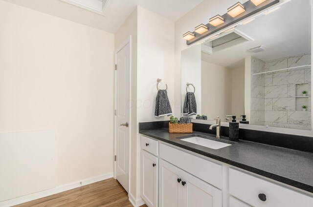 605 Frebis Ave, Columbus, OH 43206 - full bathroom featuring vanity, wood finished floors, and a tile shower