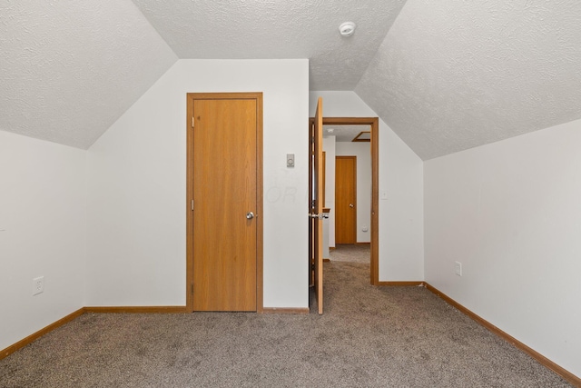 223 E 2nd St, Mansfield, OH 44902 - additional living space with a textured ceiling, lofted ceiling, and carpet flooring