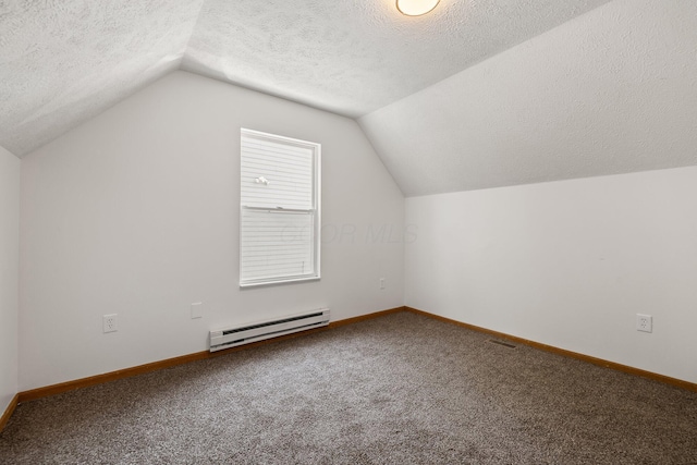 223 E 2nd St, Mansfield, OH 44902 - additional living space featuring baseboard heating, lofted ceiling, carpet flooring, and a textured ceiling