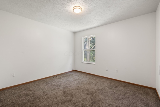 223 E 2nd St, Mansfield, OH 44902 - carpeted empty room with a textured ceiling and baseboards