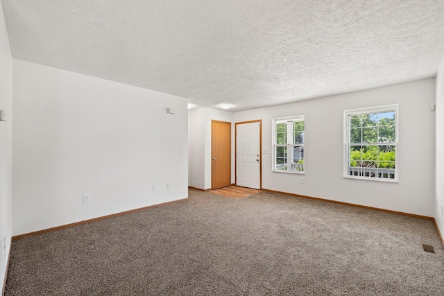 223 E 2nd St, Mansfield, OH 44902 - carpeted empty room featuring baseboards and a textured ceiling