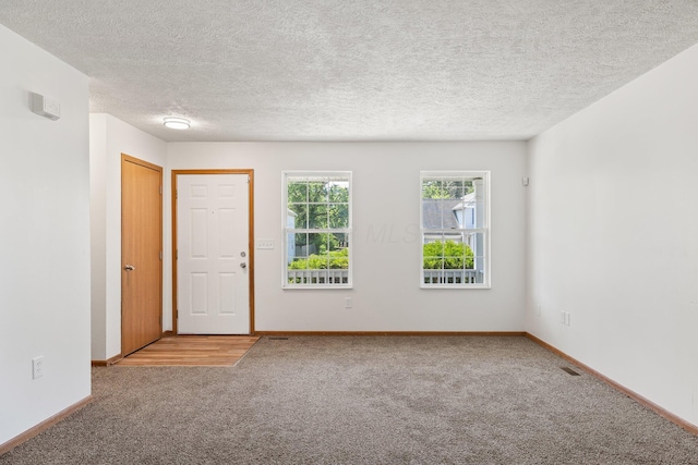 223 E 2nd St, Mansfield, OH 44902 - carpeted spare room with baseboards and a textured ceiling