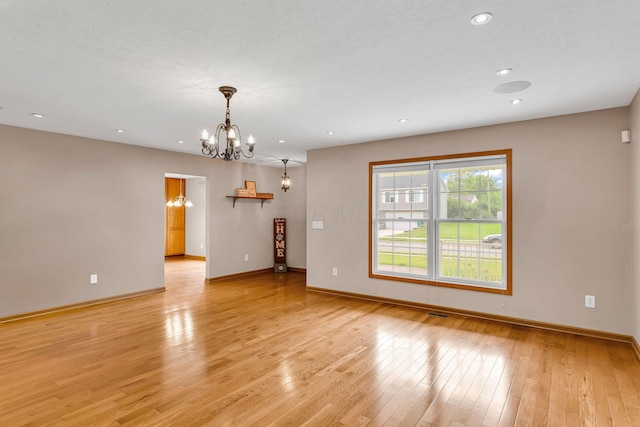 159 Hathaway Rd, West Jefferson, OH 43162 - unfurnished room with a chandelier, light wood-type flooring, and recessed lighting