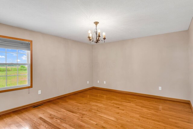 159 Hathaway Rd, West Jefferson, OH 43162 - unfurnished room featuring light wood-style flooring and a chandelier