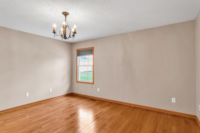 159 Hathaway Rd, West Jefferson, OH 43162 - unfurnished room featuring a chandelier and light wood-type flooring