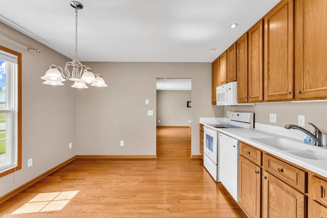 159 Hathaway Rd, West Jefferson, OH 43162 - kitchen with white appliances, healthy amount of natural light, light wood-style flooring, and a chandelier