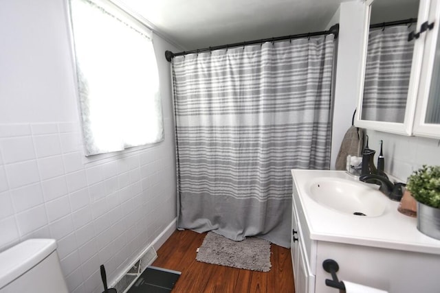 93 E 6th St, Fredericktown, OH 43019 - full bath featuring vanity, wood finished floors, tile walls, and a shower with curtain