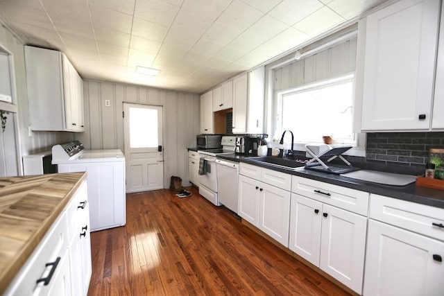 93 E 6th St, Fredericktown, OH 43019 - kitchen with washer and clothes dryer, white cabinets, dark wood-style floors, white appliances, and decorative backsplash
