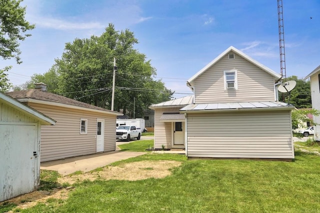 93 E 6th St, Fredericktown, OH 43019 - back of property with a yard, a standing seam roof, and a metal roof