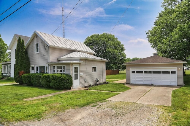 93 E 6th St, Fredericktown, OH 43019 - view of home's exterior with a detached garage and a yard