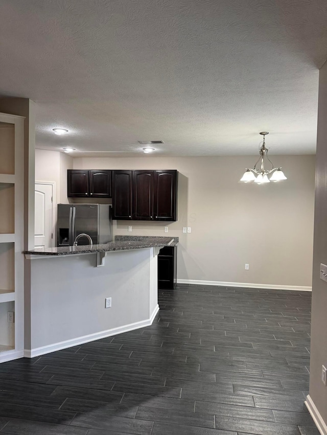3757 Birkland Cir, Lewis Center, OH 43035 - kitchen featuring stainless steel fridge with ice dispenser, wood finish floors, a breakfast bar area, dark stone countertops, and a chandelier