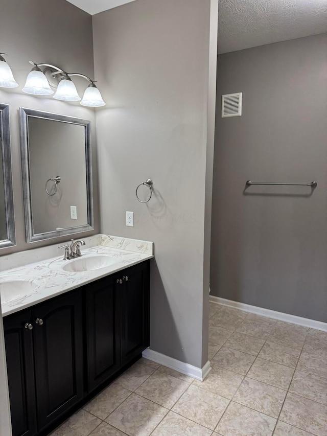3757 Birkland Cir, Lewis Center, OH 43035 - bathroom featuring double vanity, tile patterned flooring, and a textured ceiling